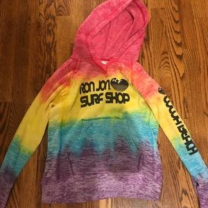 a rainbow colored ron jon surf shop sweatshirt.